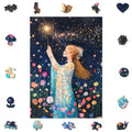 A woman in a floral dress holds a glowing sparkler under a starry night sky, surrounded by whimsical Magic Fairy Wooden jigsaw Puzzles from lycheepuzzles, featuring unique shapes amid a flower field.